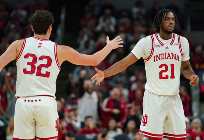Indiana Hoosiers guard Trey Galloway (32) high-fives Indiana Hoosiers forward Mackenzie Mgbako (21) during the game against Harvard in Gainbridge Fieldhouse in Indianapolis, Ind. on Sunday, Nob. 26, 2023.